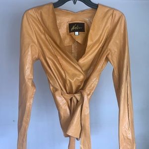 Woman’s designer leather jacket color orange size 4 in perfect condition